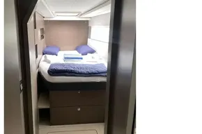 Luxurious cabin interior of 2022 Leopard 45 yacht with cozy bedding and modern design.