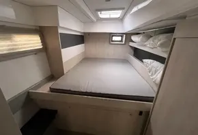 Interior cabin of 2019 Leopard 51 Powercat with bed and storage shelves.
