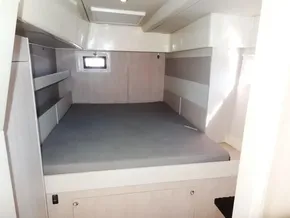 Interior cabin of 2015 Leopard 51 Powercat with bed and small window.