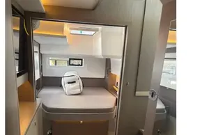 Modern interior of 2025 Leopard 46 yacht cabin with bed and backpack.