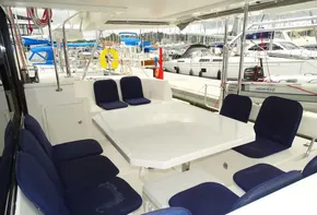 Spacious outdoor seating on 2017 Leopard 45 catamaran, docked at marina.