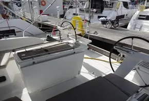 Beneteau Oceanis 46.1 2020 model yacht cockpit with dual steering wheels and dock view.