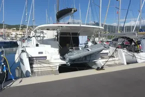 2017 Lagoon 42 catamaran docked at marina with tender boat attached.
