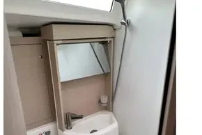 Modern bathroom in 2023 Beneteau Oceanis 51.1 yacht with compact sink and shower.