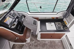 Jeanneau Merry Fisher 795 - helm seat folds forward for easy access to galley