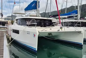 2020 Leopard 45 catamaran docked in marina, surrounded by other sailboats.