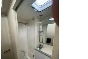 Modern bathroom interior on a 2020 Leopard 40 yacht, featuring a skylight and sleek fixtures.