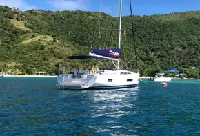 2020 Beneteau Oceanis 46.1 sailboat anchored in a scenic bay.