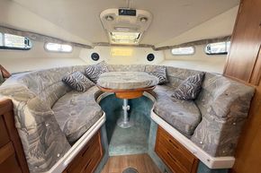 Interior of 1991 Sealine 290 Ambassador boat with cozy seating and table.