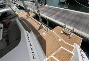 Leopard 45 catamaran docked at marina, showcasing teak deck and boarding ladder.