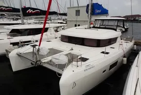 2020 Lagoon 42 catamaran docked at marina, front view.