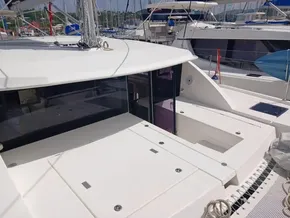 2021 Leopard 40 catamaran with spacious deck and modern design in a marina setting.