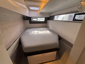 Cozy cabin interior of 2019 Leopard 40 yacht with bed and windows.