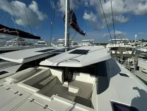 Leopard 50 catamaran deck with solar panels, docked at marina, under blue sky.