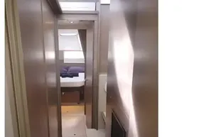 Interior hallway of 2022 Leopard 45 yacht, featuring modern design and cozy bedroom view.