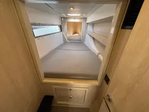Interior cabin of a 2019 Leopard 40 catamaran, featuring a cozy bed and modern design.