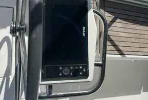 Beneteau Oceanis 46.1 2020 yacht helm with navigation system and wooden deck.