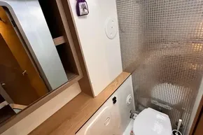 2024 Lagoon 42 yacht bathroom with modern design and wood accents.