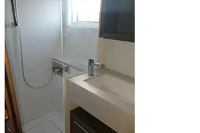 Modern bathroom in 2020 Lagoon 46 yacht with shower and sink.
