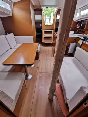 Interior of 2020 Jeanneau Sun Odyssey 410 sailboat with cozy seating and wooden finishes.