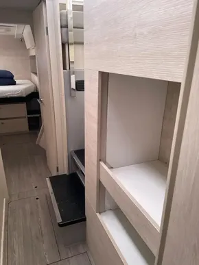 Interior of a 2020 Leopard 50 yacht, featuring modern wood finishes and storage spaces.