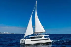 Sailing catamaran Leopard 46, 2025 model, cruising on open ocean under clear blue sky.