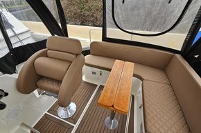 Luxurious interior of 2023 Balt 818 Titanium boat with plush seating and wooden table.