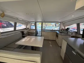 Spacious interior of 2019 Leopard 40 catamaran with modern kitchen and dining area.