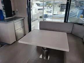 Interior of 2021 Leopard 40 yacht with modern dining area and marina view.