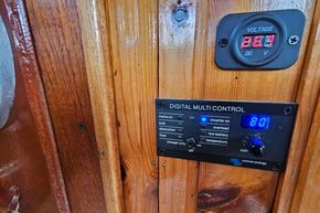 Digital control panel on 1921 Classic Dutch Barge, displaying voltage and settings.