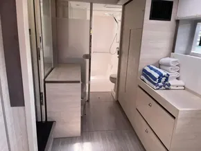 Modern bathroom interior of 2020 Leopard 50 yacht with shower and storage.