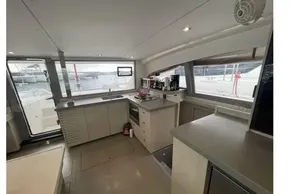Modern kitchen interior of 2020 Leopard 40 catamaran with appliances and large windows.