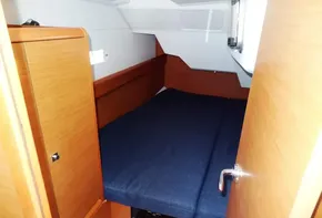 2017 Jeanneau Sun Odyssey 389 cabin with blue mattress and wooden interior.