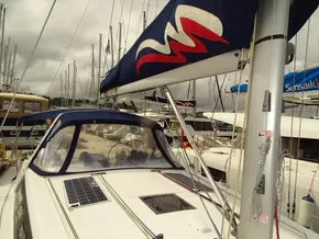 2017 Beneteau Oceanis 45 sailboat docked, featuring solar panels and a blue canopy.