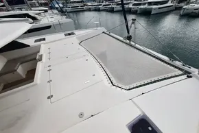 2019 Leopard 50 catamaran deck with netting, docked at marina.