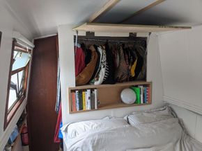 Wardrobe with side access behind picture frame