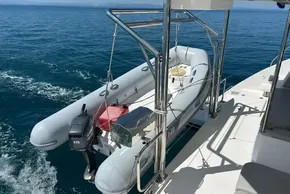 Inflatable dinghy on Leopard 42 yacht, 2022 model, with outboard motor, on calm ocean.