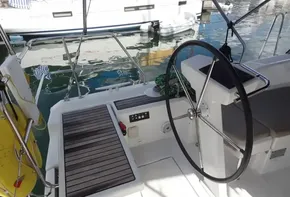 Beneteau Oceanis 46.1 2020 sailboat cockpit with steering wheel and wooden deck.