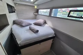 Cozy bedroom interior on a 2020 Leopard 45 yacht with natural light.
