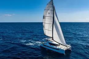 Sailing catamaran Leopard 46, 2025 model, cruising on open ocean under clear blue sky.