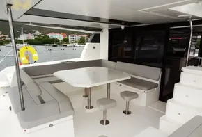 Leopard 50 yacht 2020 model, spacious outdoor seating area with table and stools.