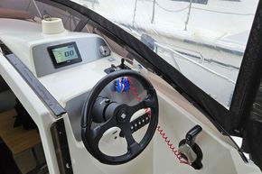 Cockpit of 2023 Balt 818 Titanium boat with steering wheel and digital display.
