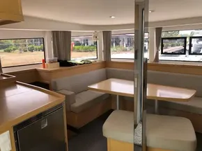 Interior of 2020 Lagoon 42 catamaran with dining area and large windows.