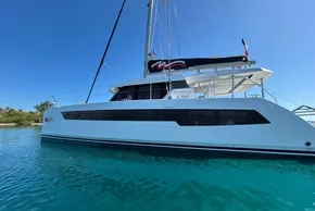 2022 Leopard 42 catamaran on clear blue water under a sunny sky.