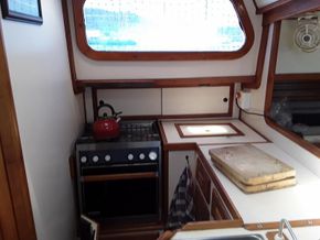 Galley with gas stove and fridge top
