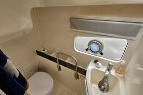 Compact bathroom in 2023 Balt 818 Titanium boat with porthole and modern fixtures.