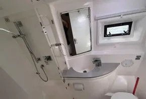 Modern bathroom interior of 2019 Leopard 51 Powercat yacht with shower and sink.
