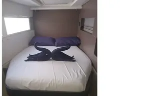 Luxurious cabin interior of 2022 Leopard 45 yacht with elegant bedding and towel swans.