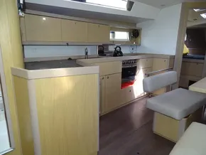 Interior of 2017 Beneteau Oceanis 45 yacht, featuring modern kitchen and seating area.