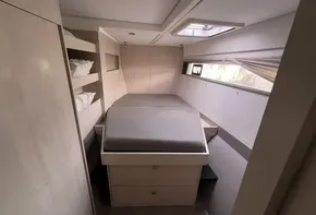 2019 Leopard 51 Powercat cabin with bed, storage, and window.